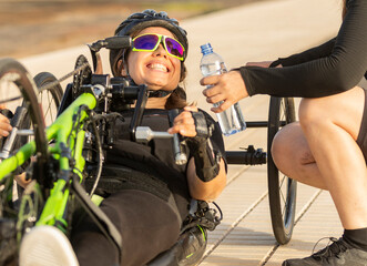 Handbike athlete receiving water during a race