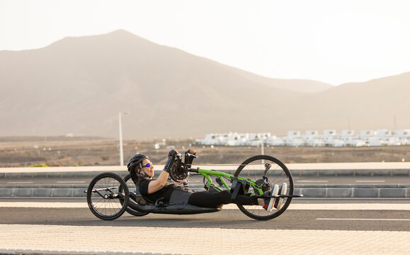 Determined handbike athlete training on scenic road