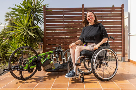 Female athlete with handbike ready for competition