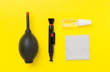 Different camera cleaning tools on color background, top view