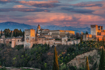 Alhambra Arabic Palace in Granada,Spain Illuminated at Twilight. Sunset Over Alhambra - obrazy, fototapety, plakaty
