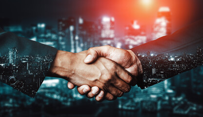Double exposure image of business people handshake on city office building in background showing...