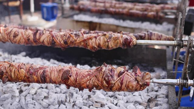 Easter in Greece, process of cooking traditional greek Easter dish - Souvla, grilled lamb, sheep and goat bbq, grilling over charcoal in the streets of Athens, Greece