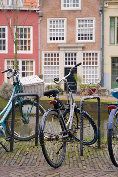 Picturesque Netherlands. Bicycles parked alongside a channel on beautiful old buildings background.