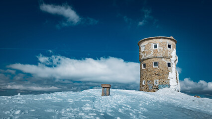 Old tower on the mountain summit called 