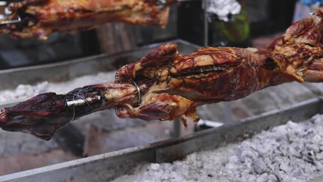 Easter in Greece, process of cooking traditional greek Easter dish - Souvla, grilled lamb, sheep and goat bbq, grilling over charcoal in the streets of Athens, Greece