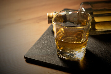 Glass of whiskey on the wooden table