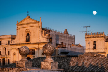 Glimpse of the baroque city of Noto: view of the facade of the church of the Santissimo Salvatore from the terrace of Palazzo Ducezio, seat of the town hall