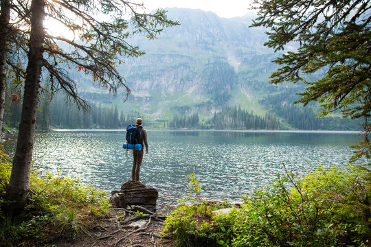 Man Hiking to a summer lake in the mountains