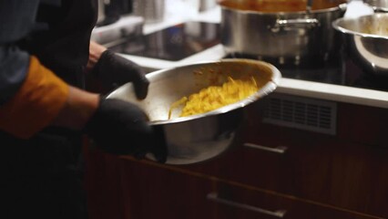 Group of people in a cooking class studio, adults preparing different dishes in the kitchen together, people in aprons learn on culinary master class, chef uniform, hands in gloves, italian cuisine