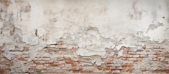 Fototapeta premium Peeling paint is visible on a detailed close-up of a weathered brick wall, showing signs of aging and wear