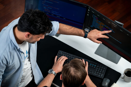 IT developers discussing online software development information on pc screen, creating program coding for latest version application on website. Concept of brainstorming firmware updated. Sellable.