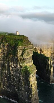 Cliffs of Moher shrouded in low clouds on a sunset