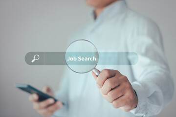 Business people use a magnifying glass to search for information. Job search, find a job, job interview, unemployment, recruitment. Search technology, Search Engine Optimization, SEO.