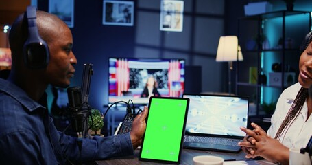 Isolated screen tablet in front of show host recording podcast, enjoying nice conversation with...