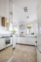 Stylish interior of open space white kitchen