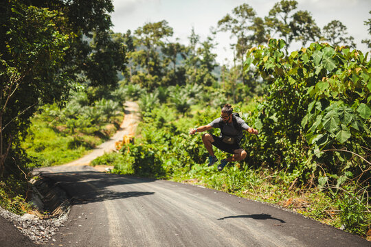 Adventurous jump on a scenic Indonesian road