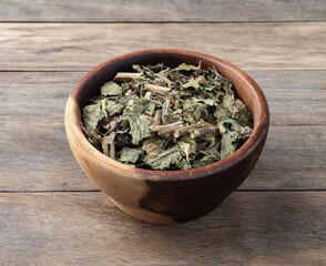 Lemon balm or Melissa dried tea leaves on a bowl over wooden table