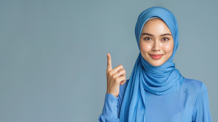 Malay woman in blue ribbed V-Neck Body, hands in point away pose