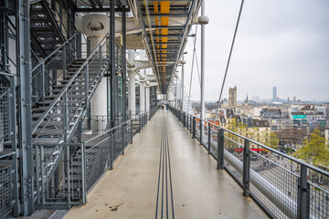 A deserted walkway with a cityscape view from the Centre Pompidou, showcasing modern architectural...