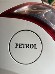 Petrol written on the petrol tank of a whit color swift car