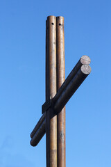 A wooden cross, contrasting with a beautiful blue sky, is empty, without the crucified, already resurrected Christ...