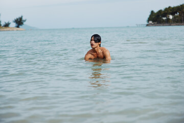 Active Asian Man Enjoying Fun Water Activities on a Tropical Beach Vacation