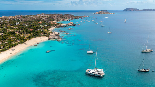 A tranquil tropical cove serves as an anchorage for various boats