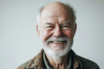 Portrait of a senior man with white beard and mustache smiling at the camera