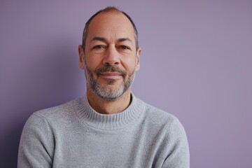 Portrait of a handsome mature man with grey hair on a purple background