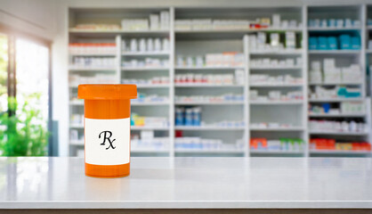 White pharmacy counter with orange prescription medication bottle and Rx on a lable and copy space
