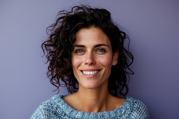 Portrait of a smiling woman looking at the camera isolated on a purple background