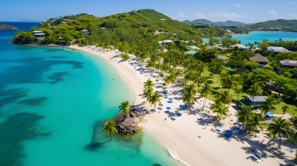 Aerial view of beautiful tropical beach with white sand, turquoise water and palm trees.