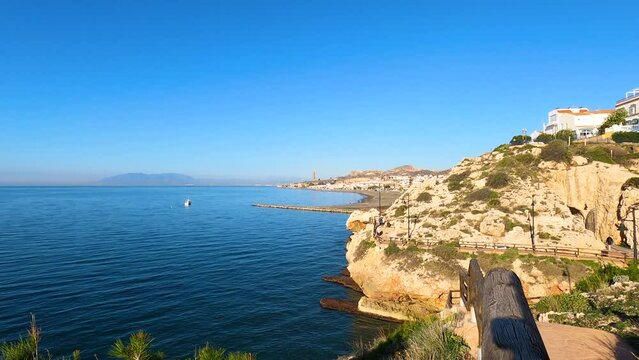 Morning walking on paths above rocks and through "El Cantal" tunnels in Rincon de la Victoria, Spain