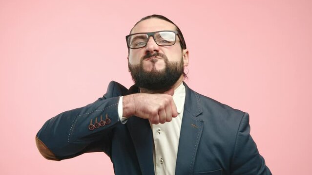 A man in a blue suit and white shirt making a 'cut-throat' hand gesture, symbolizing strong disapproval or indicating the end of a discussion with a pink background. Camera 8K RAW.
