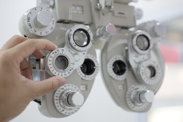 Phoropter eye exam, hand using Phoropter eye test in hospital 