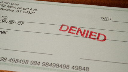 6 photo of blank green generic check on table with denied stamp