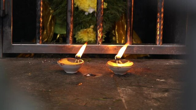 Two diya oil lamps inside a temple. Diwali festival concept.