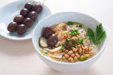 Bubur Ayam Spesial contains white rice porridge with side dishes of fried chicken slices