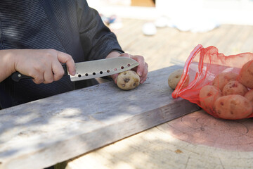 じゃがいもを切る女性