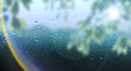 梅雨　雨の滴のついた窓ガラスと前面の木の葉とレンズフレア太陽の日差しの背景　ガラス越し奥の山林・森林の風景　6月・梅雨明け・水滴・日本・季節 - obrazy, fototapety, plakaty