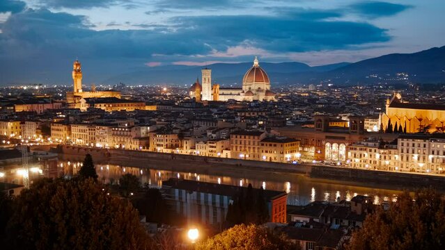 Twilight establishing shot of Florence, Tuscany, Italy captures the Florence Cathedral and Palazzo Vecchio bathed in the serene glow of dusk