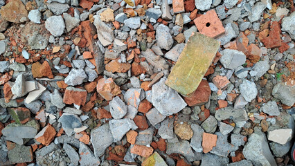 Pile of broken red bricks and fragments of concrete from destroyed building	
