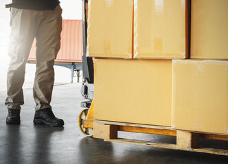 Workers Unloading Package Boxes on Pallet in Warehouse. Hand Pallet Truck Loader. Delivery Service. Supply Chain Shipment Goods. Distribution Supplies Warehouse Shipping Logistics.