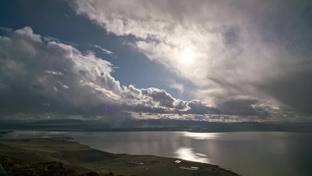 Timelapse of clouds moving over Utah Lake viewing the sun moving through the sky.