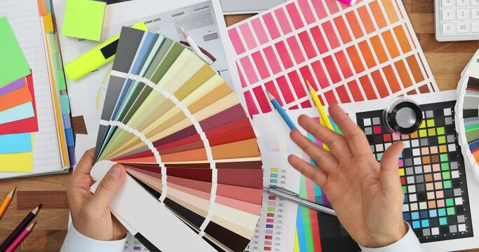 Man designer chooses colors on pallet for flat renovation