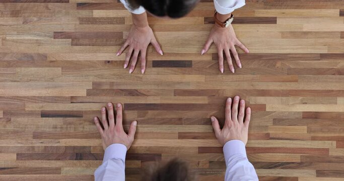 Team furiously puts hands on table during argument