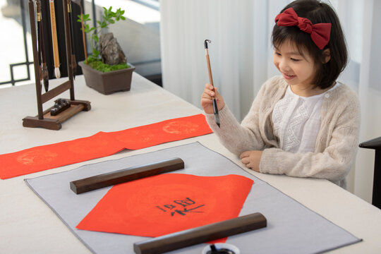 Little Girl Writing New Year Couplets