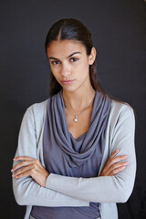 Obraz premium Portrait, serious and business with woman, arms crossed and professional on a dark studio background. Face, creative entrepreneur or consultant with startup and company owner with confidence or agent