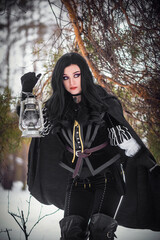Beautiful young enchantress walking in the winter forest.
